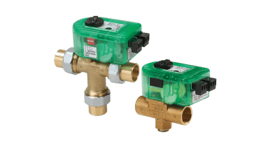 two green mixing valves with brass fittings side by side